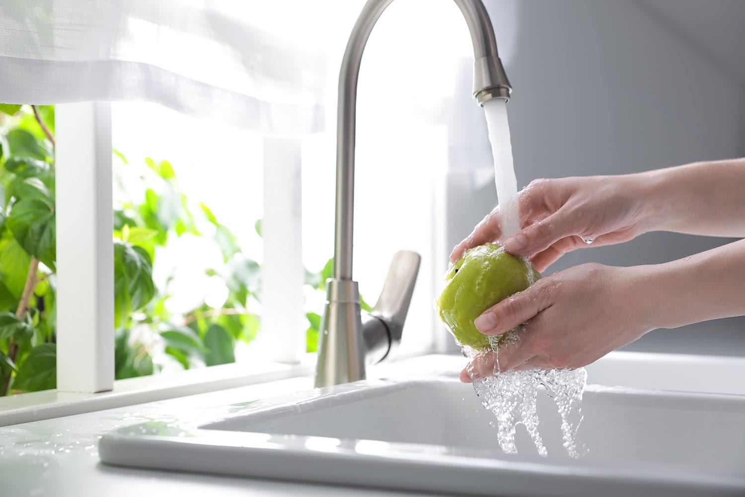 rinsing apple with water