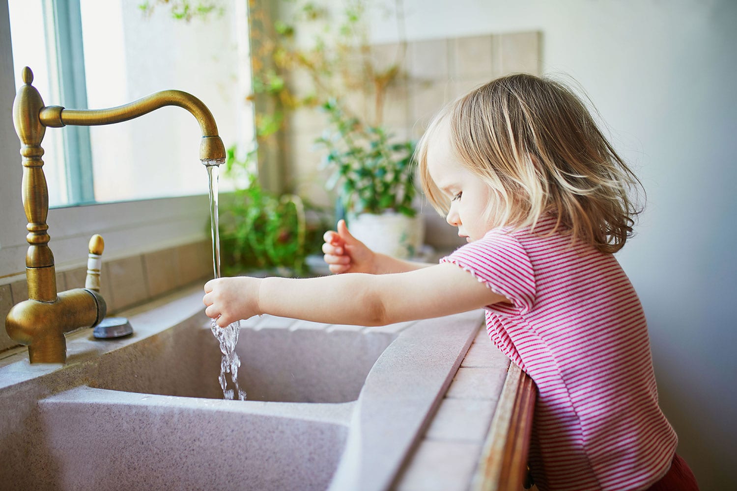 little girl washing her hands